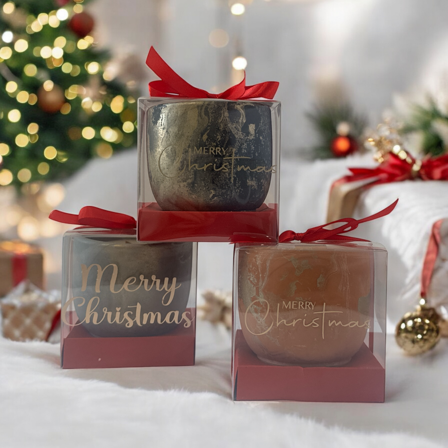 'Merry Christmas' candles in clear boxes with red ribbons on a festive background.