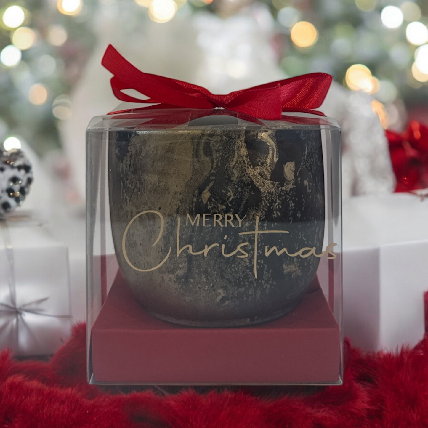 Decorative pot with 'Merry Christmas' text in a clear box with a red bow, against a festive background.