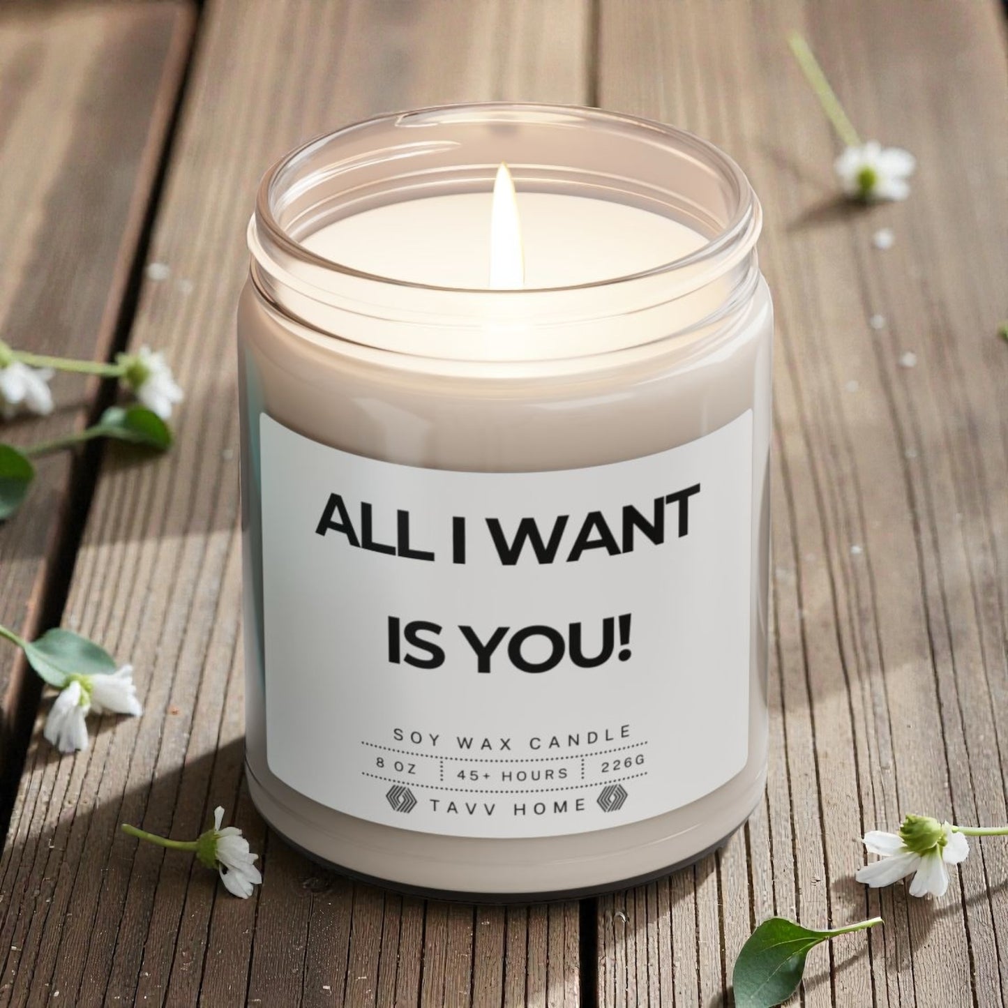 Candle with 'All I Want Is You!' label on a wooden surface with flowers. Candle in a jar with a label reading 'All I Want Is You!' on a wooden surface. Valentine Gift for her/him