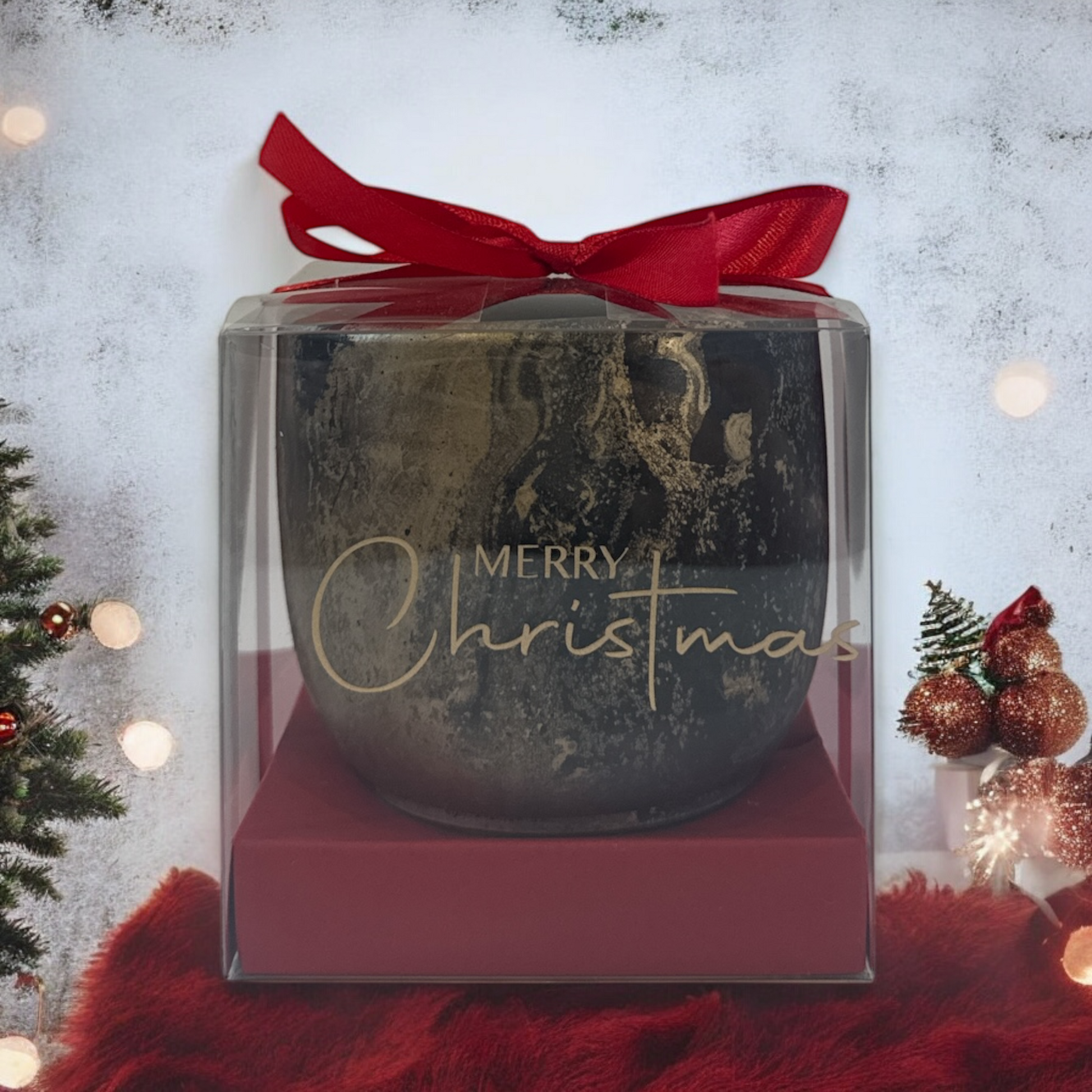 Decorative Christmas ornament in a clear box with a red ribbon on a festive background.