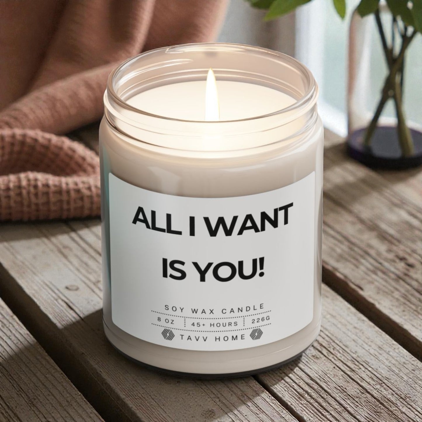 Candle in a jar with a label reading 'All I Want Is You!' on a wooden surface. Valentine Gift for her/him